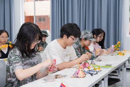 【图片2】志愿者们围坐桌前,制作香囊与手作花