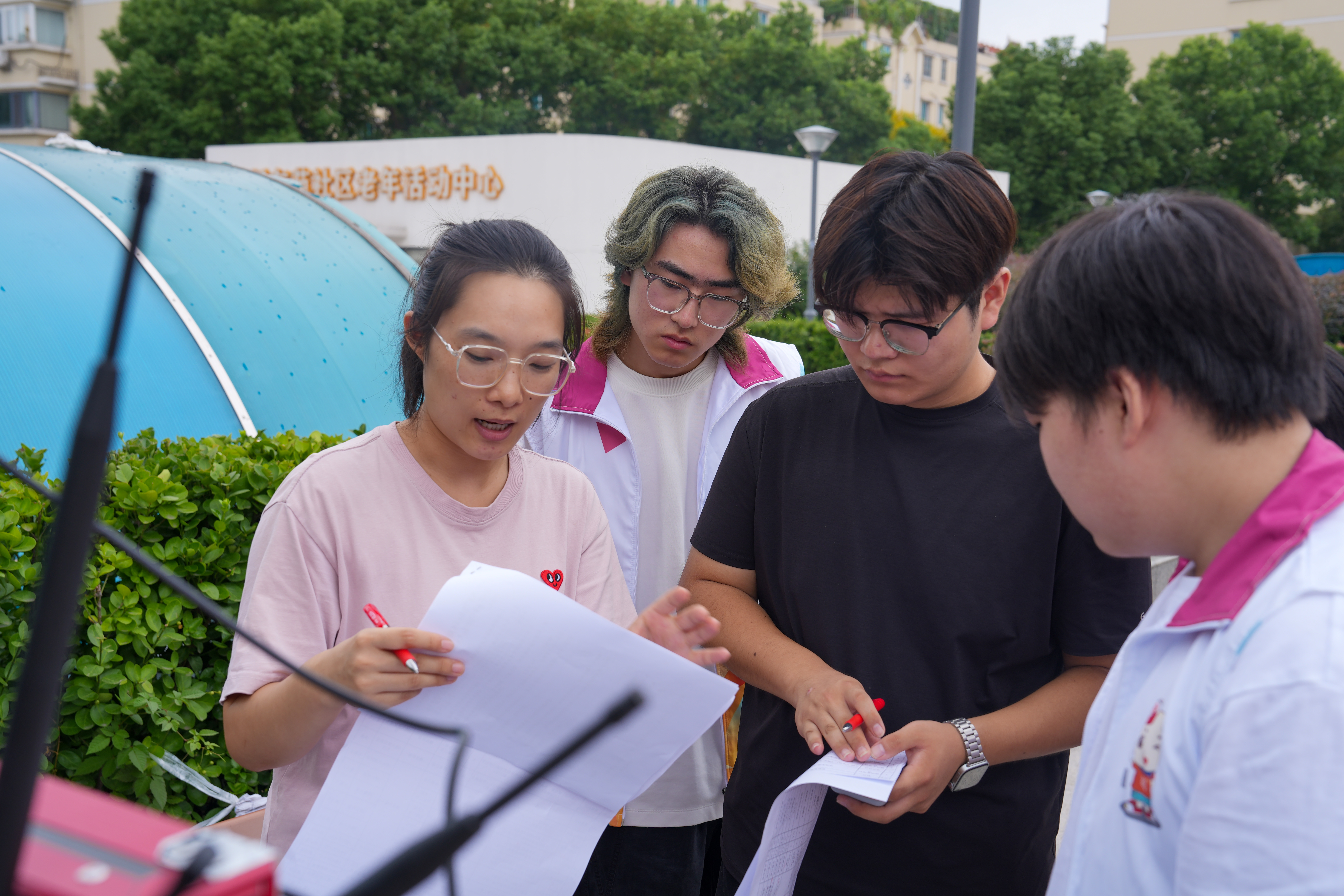 【图片3】志愿者在后台核对演出流程与串场词